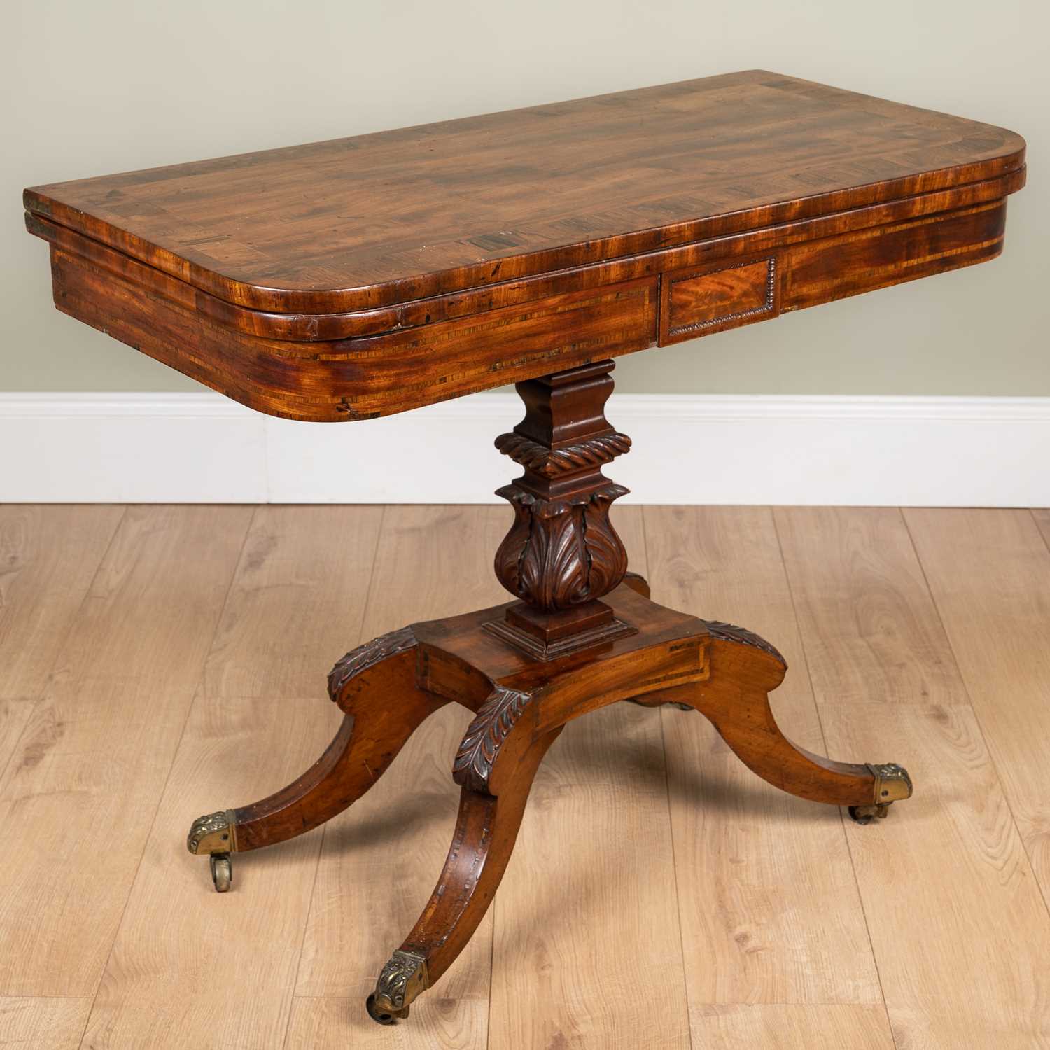 A George IV mahogany foldover card table with rosewood cross banded top, carved support and four - Image 2 of 7