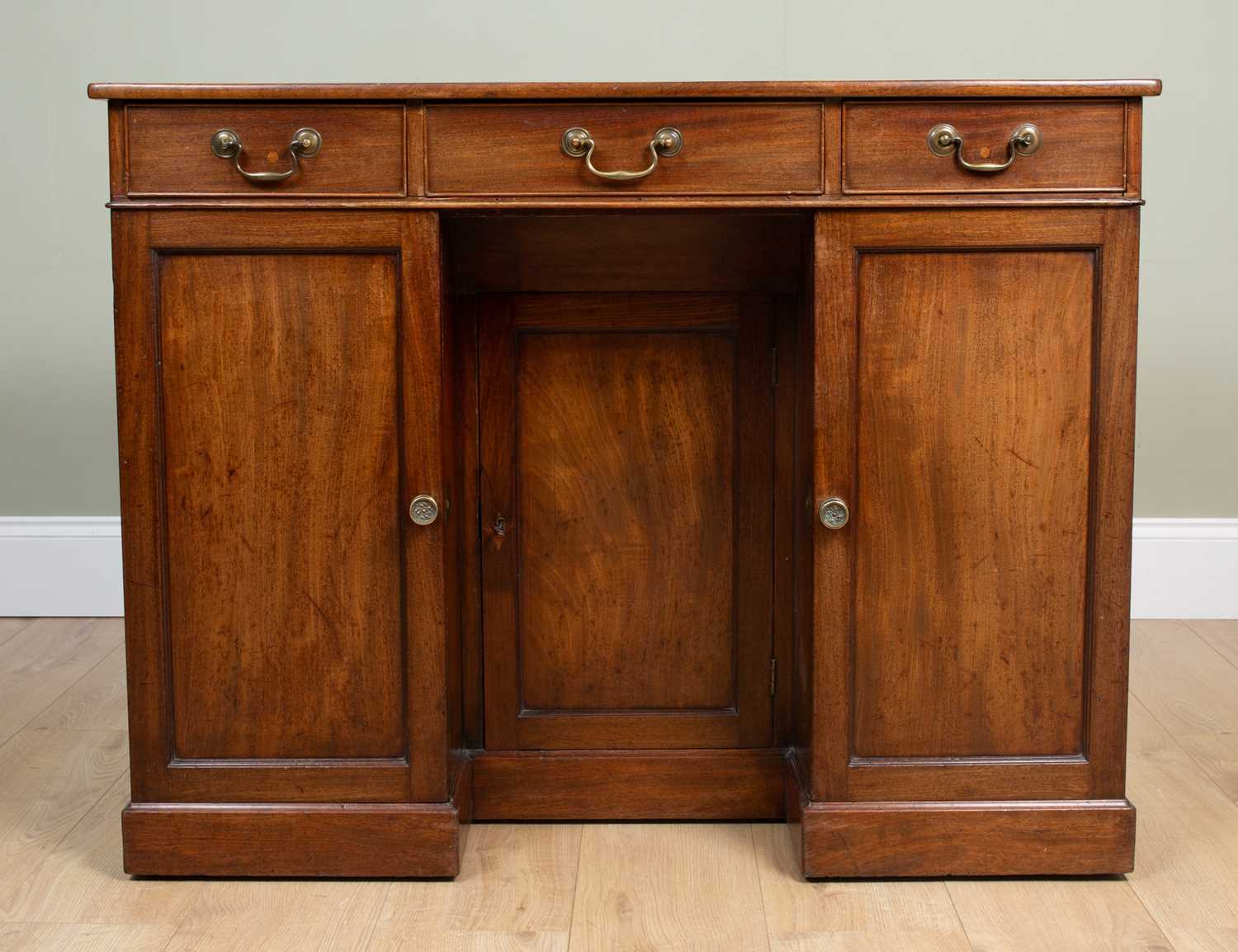 A 19th century mahogany knee hole desk with black leather inset top over two drawers and three