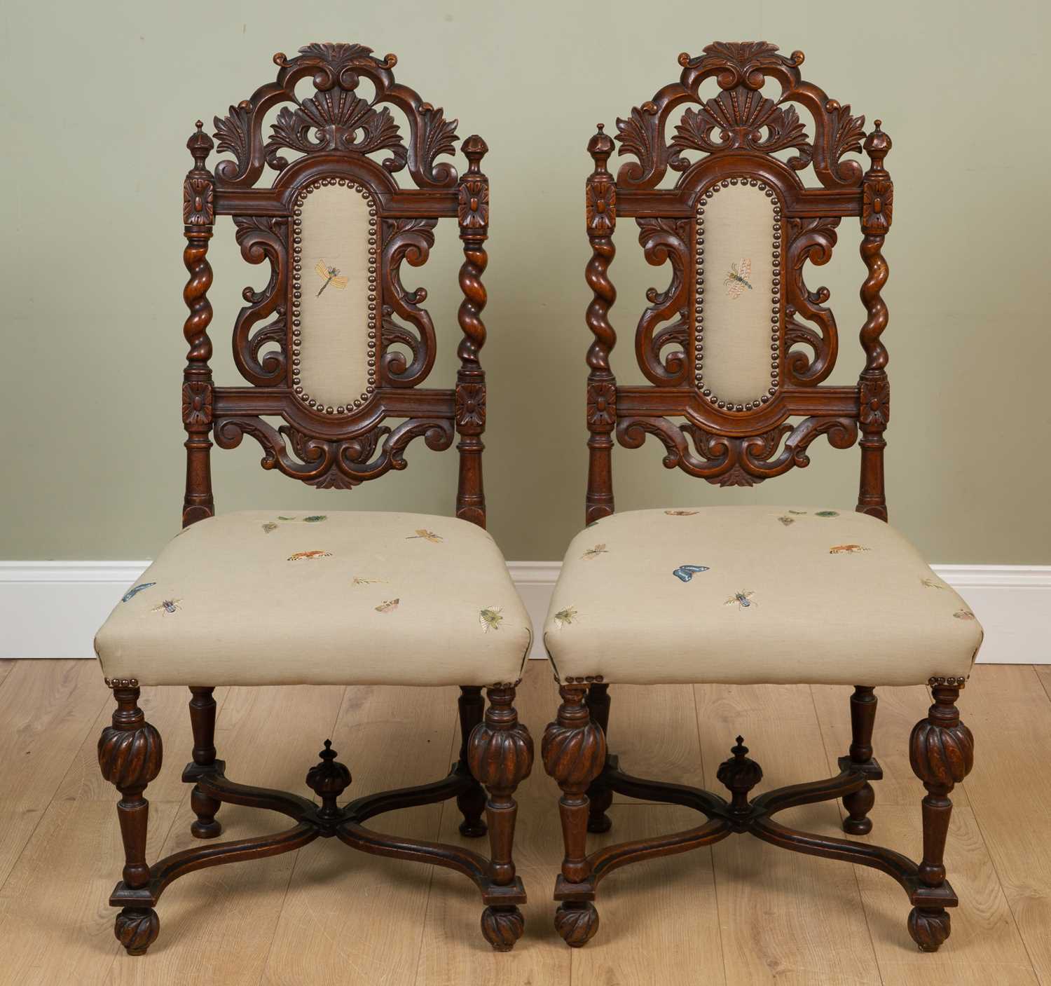 A pair of 19th century oak side chairs with carved decoration and upholstered backs and seats,