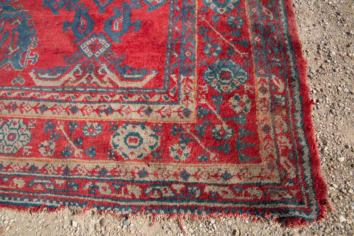 A large red ground Turkey carpet with geometric decoration, 430cm x 407cmStains, marks and minor - Image 4 of 7