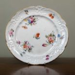 A Nantgarw porcelain plate, the moulded border within a gilt rm and decorated overall with insects