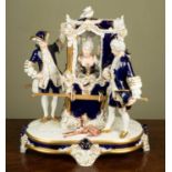 A Royal Dux porcelain figure group modelled as a lady in a sedan chair with attendants and dog,