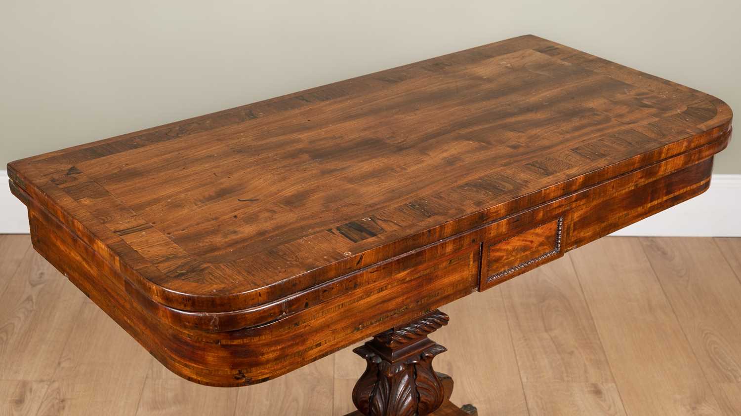 A George IV mahogany foldover card table with rosewood cross banded top, carved support and four - Image 3 of 7