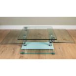 A contemporary glass metamorphic coffee table with square top opening with extra sections to each