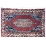 An old Maszlagn red and blue ground rug, 197cm x 131cm