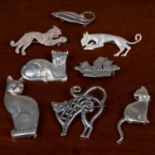 Two silver cat brooches, five further cat brooches, and a Mexican leaf brooch stamped sterling (7).