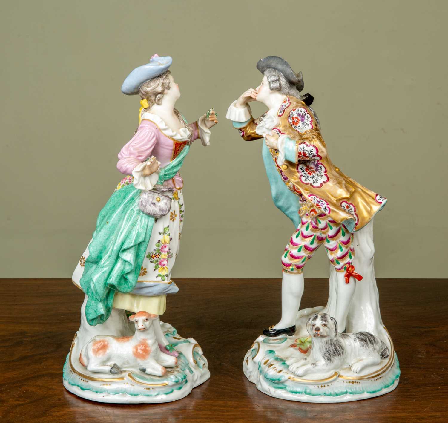 A pair of antique figurines depicting a gentleman and his belle, the gentleman with a dog resting at - Image 4 of 5