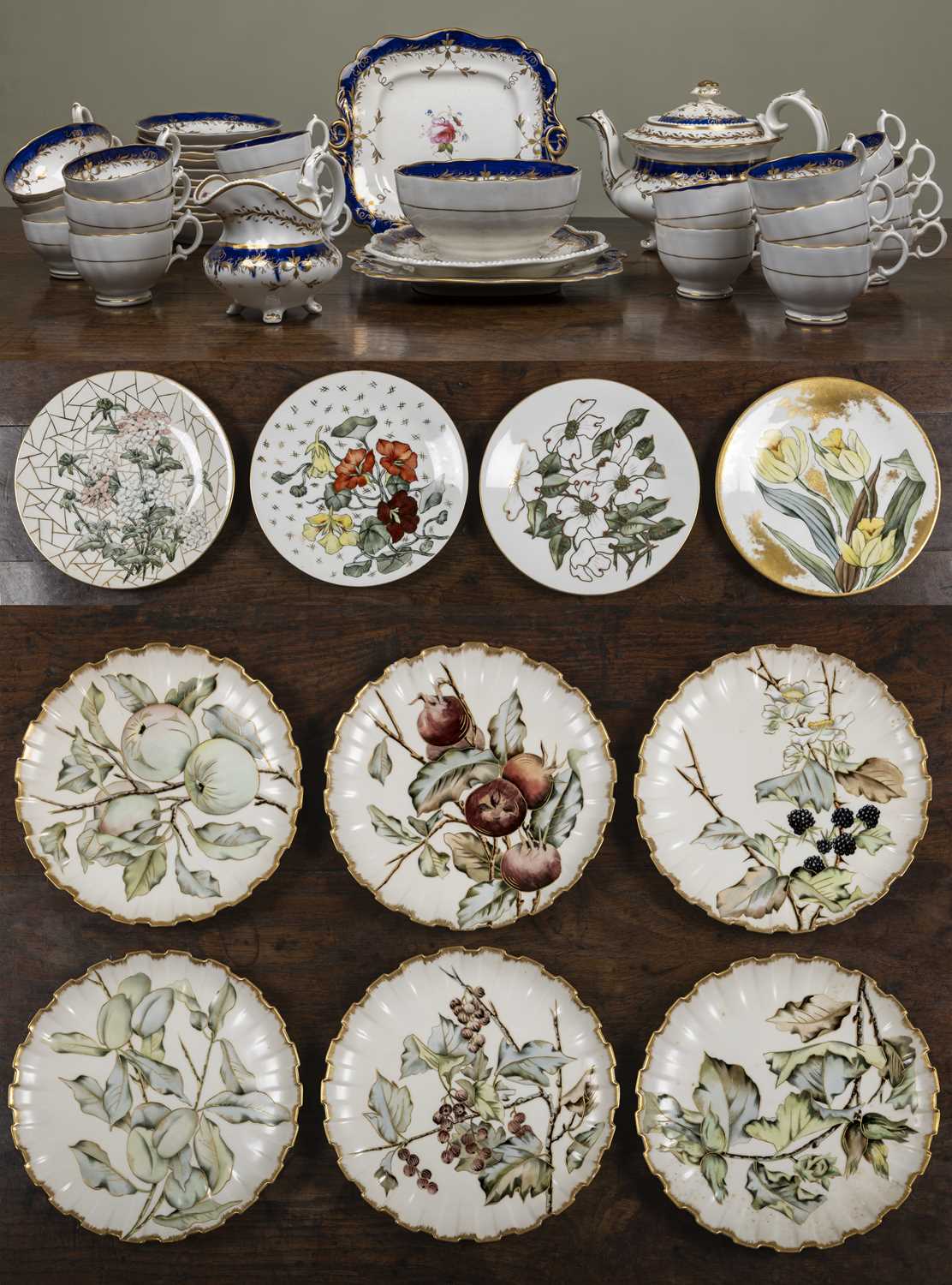 A 19th century part tea set with rose decorations, unmarked and with a teapot, teacups, coffee cups,