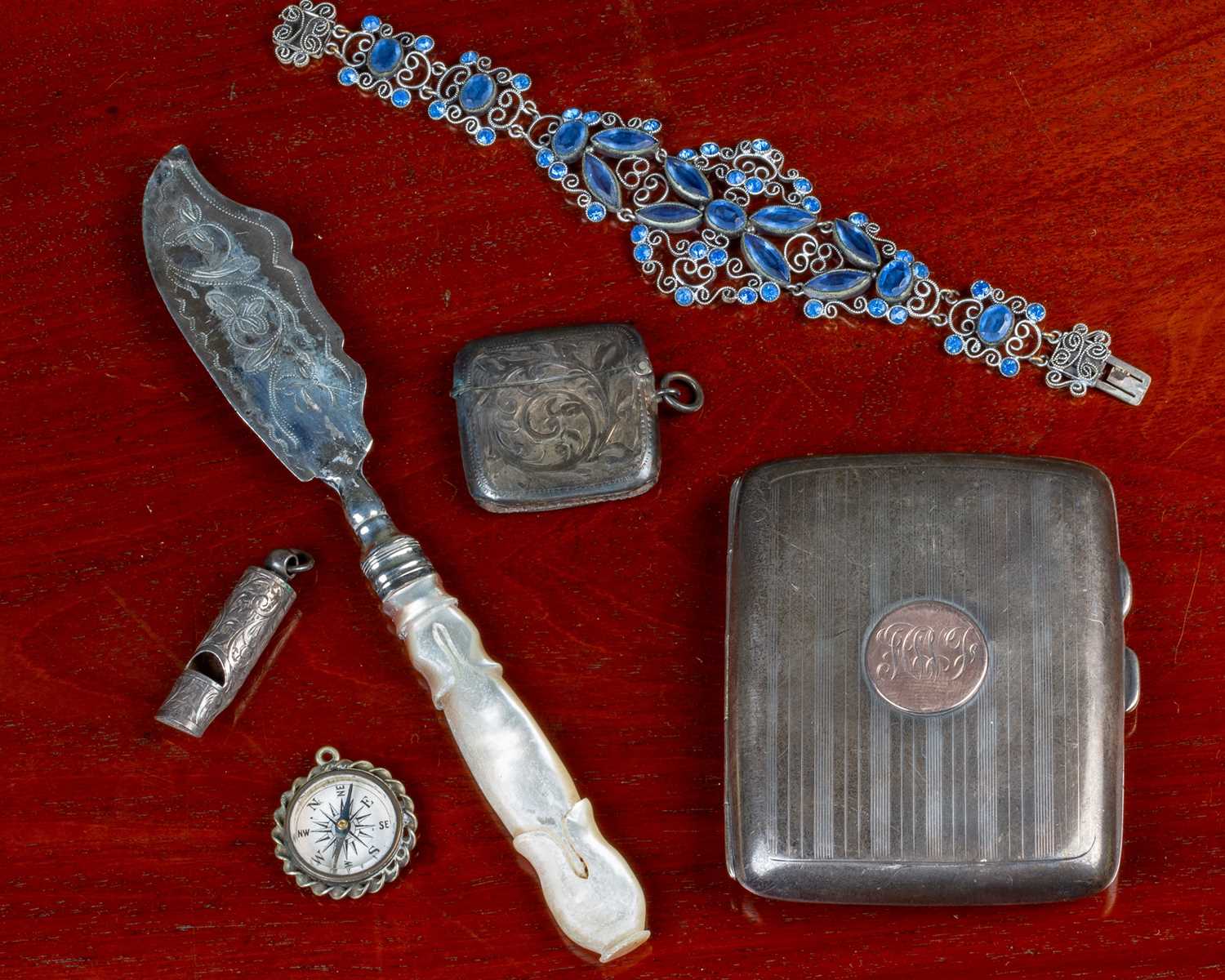 A continental white metal bracelet set with blue stones; together with a silver cigarette case