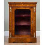 A 19th century walnut and satinwood inlaid credenza or side cabinet with a single glazed door and