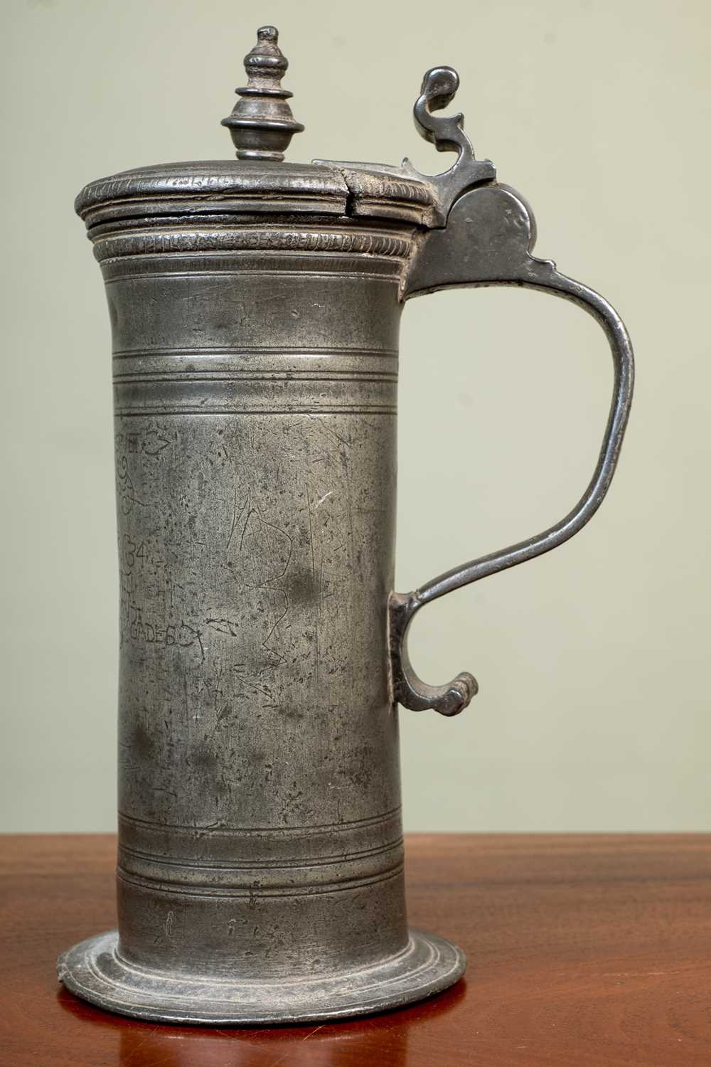 An antique continental pewter lidded tankard, possibly 18th Century Dutch, with crest and
