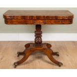 A George IV mahogany foldover card table with rosewood cross banded top, carved support and four