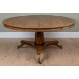 A Regency style rosewood circular breakfast table with brass inlaid decoration, hexagonal stem and a