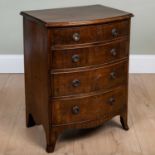 A small modern mahogany bow fronted chest of four graduated drawers with ring handles and splaying