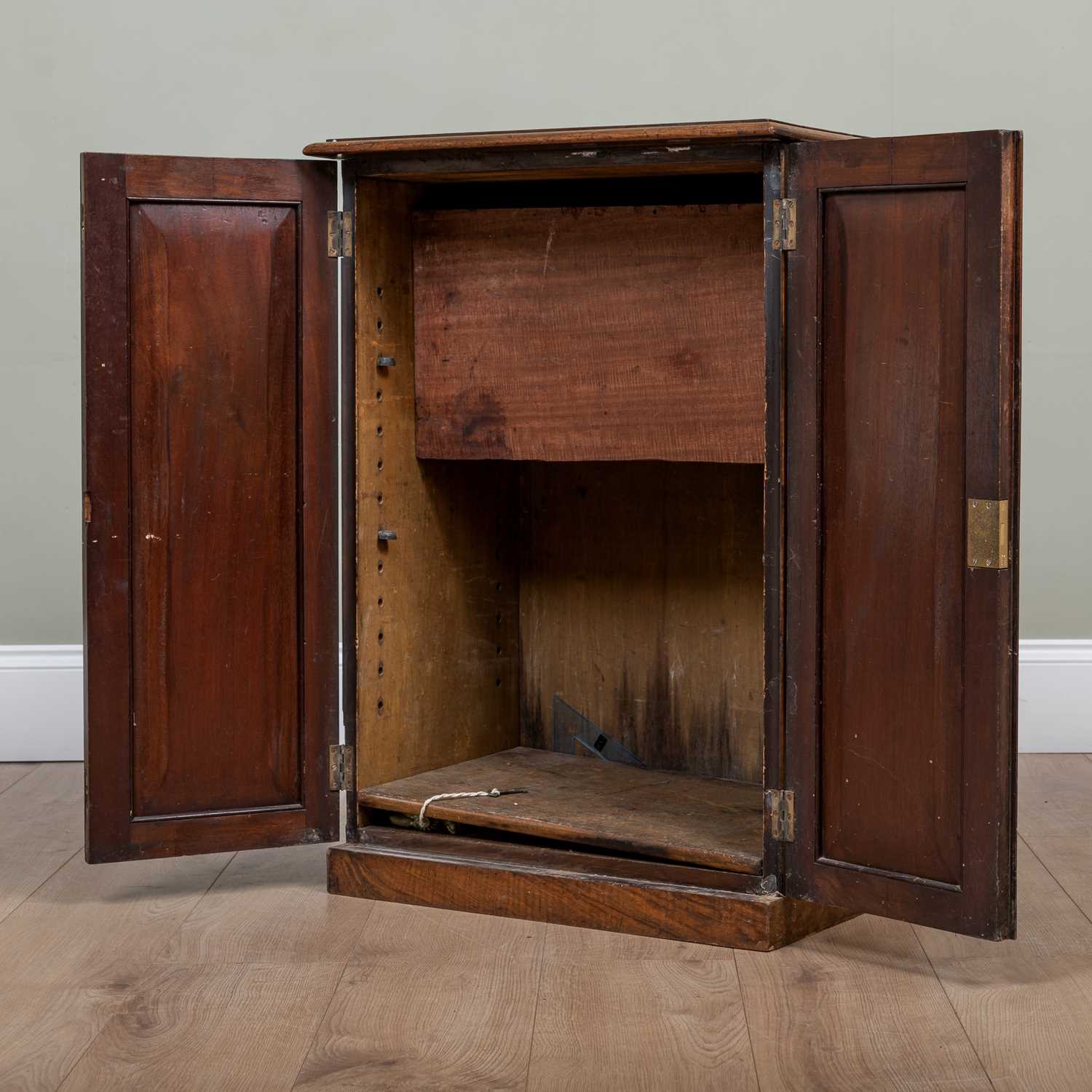 A 19th century walnut small cupboard with panelled doors enclosing adjustable shelves, with carrying - Image 2 of 3