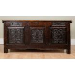 A 17th century oak coffer or chest with chip-carved triple-panelled front and bearing initials 'L A'