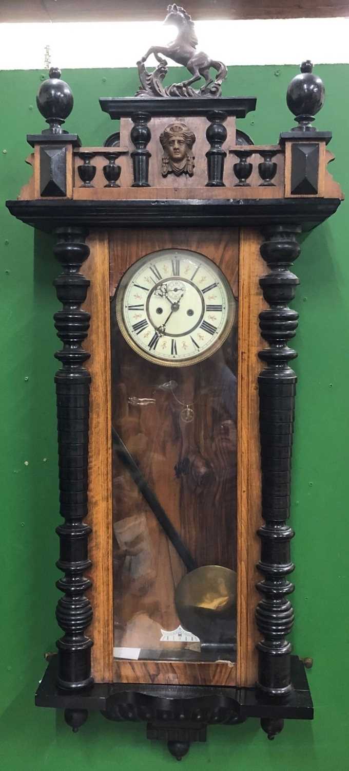 A Vienna regulator-type wall clock with two-part dial and horse crest, 52cm wide x approximately