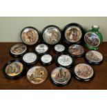 A collection of various pot lids to include The Village Wedding, toothpaste lids, The Game Bag,