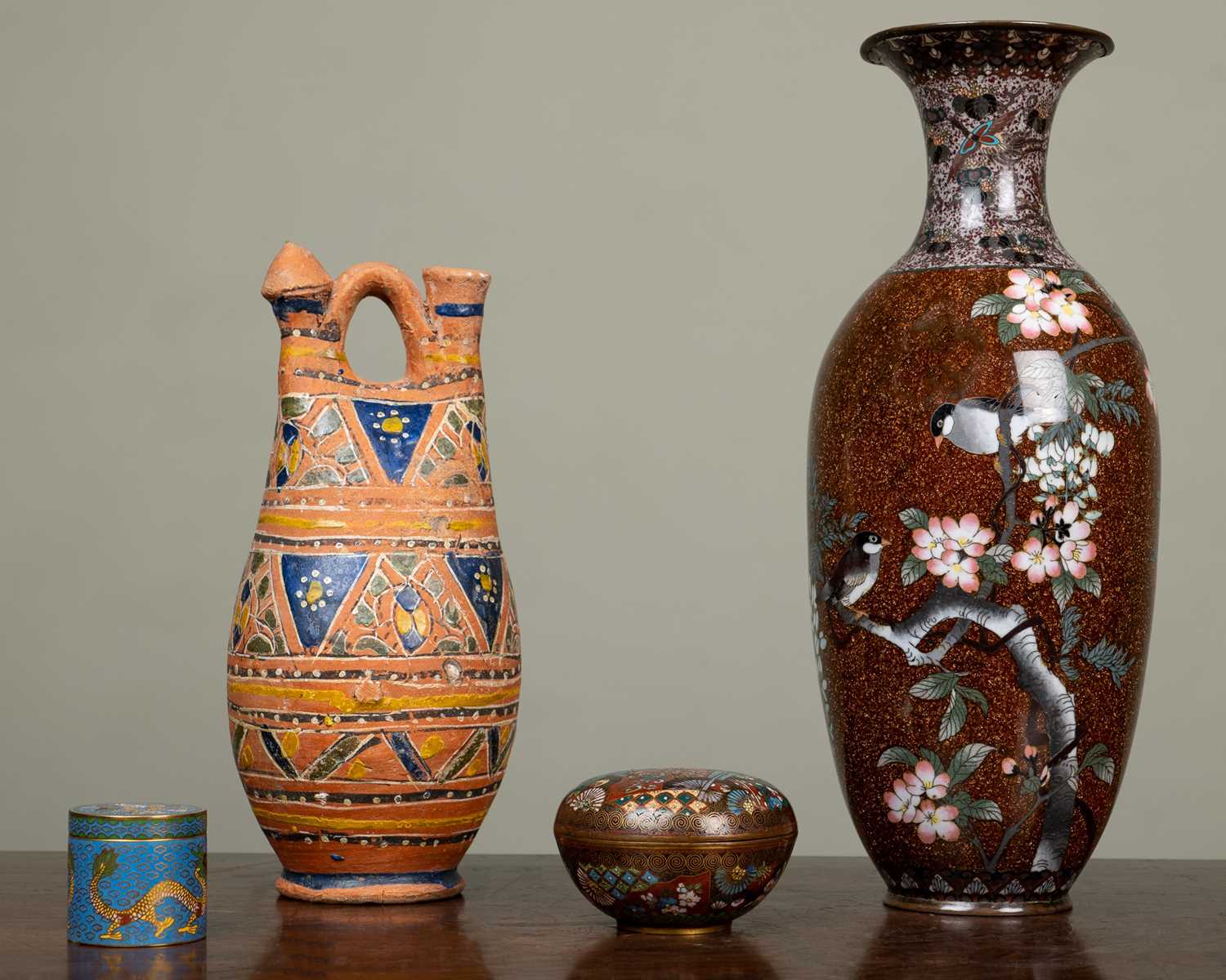 An antique cloisonné vase, the gold ground decorated with birds amongst prunus blossom, 34cm high;