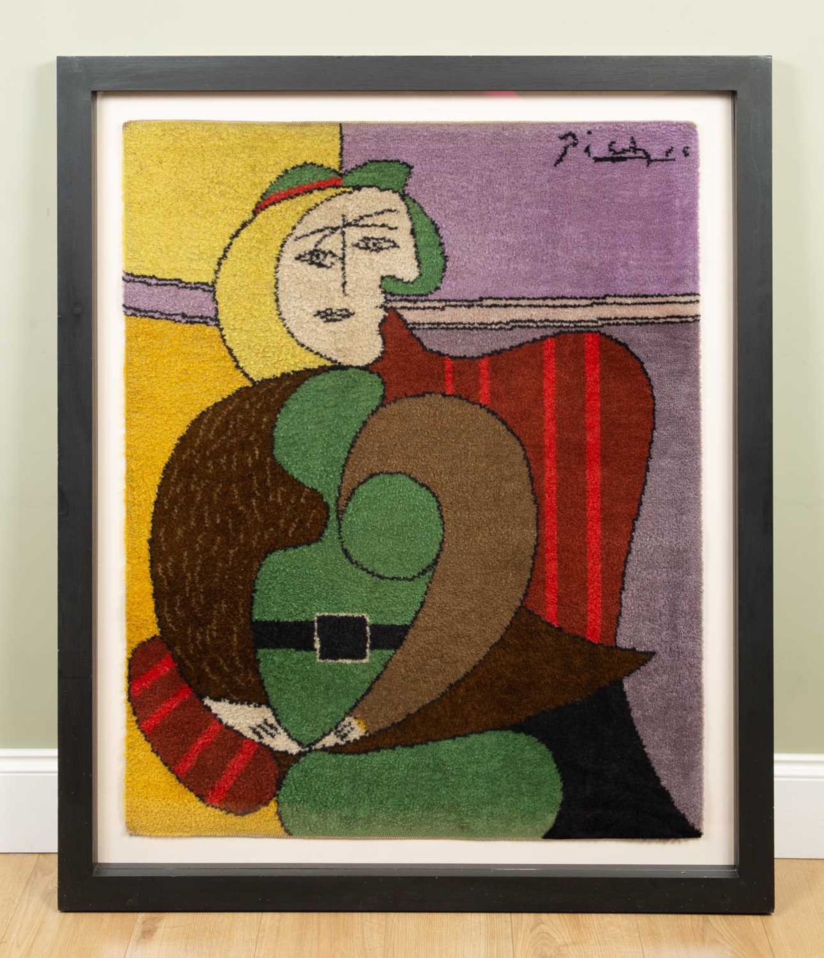 After Pablo Picasso, a framed art rug, Femme Assise Dans Un Fauteuil Rouge, 90cm x 112cm, the