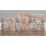 A set of three limed carved wood pine panels decorated with ribbon tied ornaments depicting three of