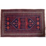A red ground Baluch rug 113cm x 183cmAt present, there is no condition report prepared for this lot,