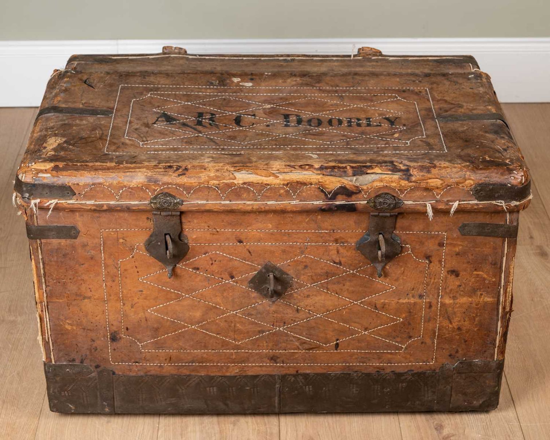A 19th century leather and iron bound trunk with wrought iron carrying handles to the side and