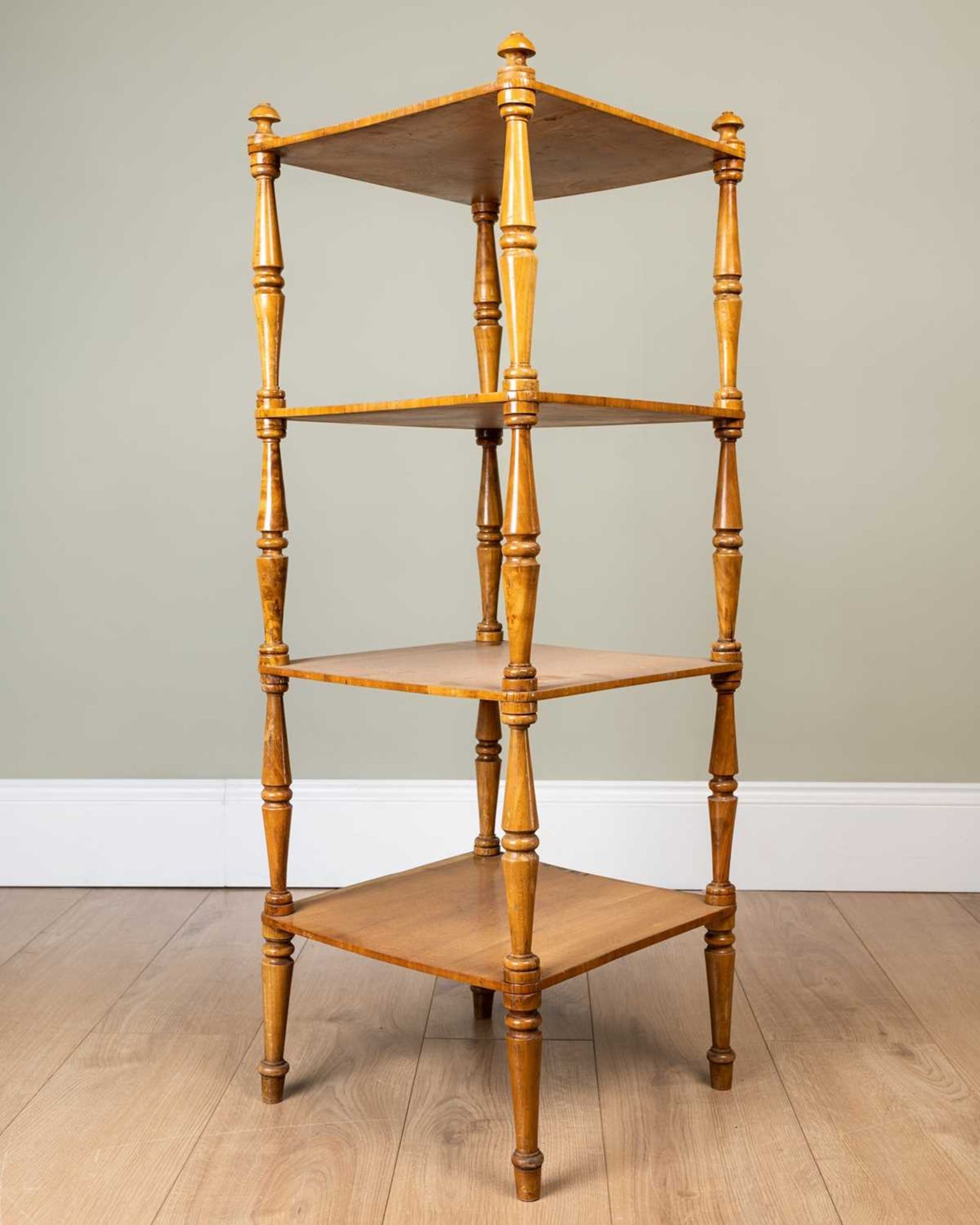 A satinwood four-tier whatnot with turned supports, the top 35.5cm square, standing 98cm highMinor