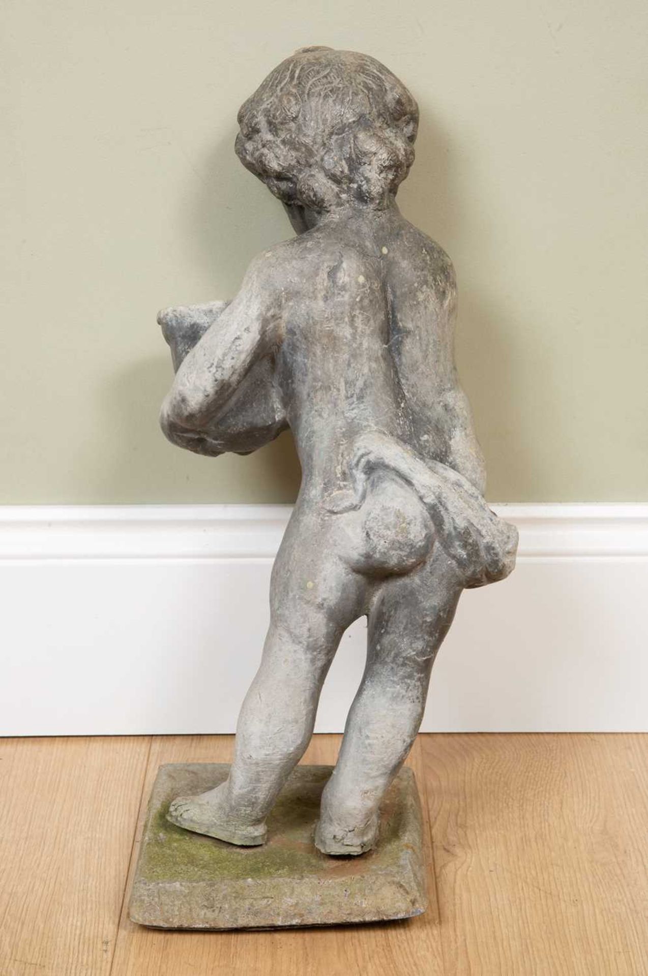 An antique lead putti in a standing pose with a basket, on a square plinth, 20cm wide x overall 52cm - Image 2 of 3