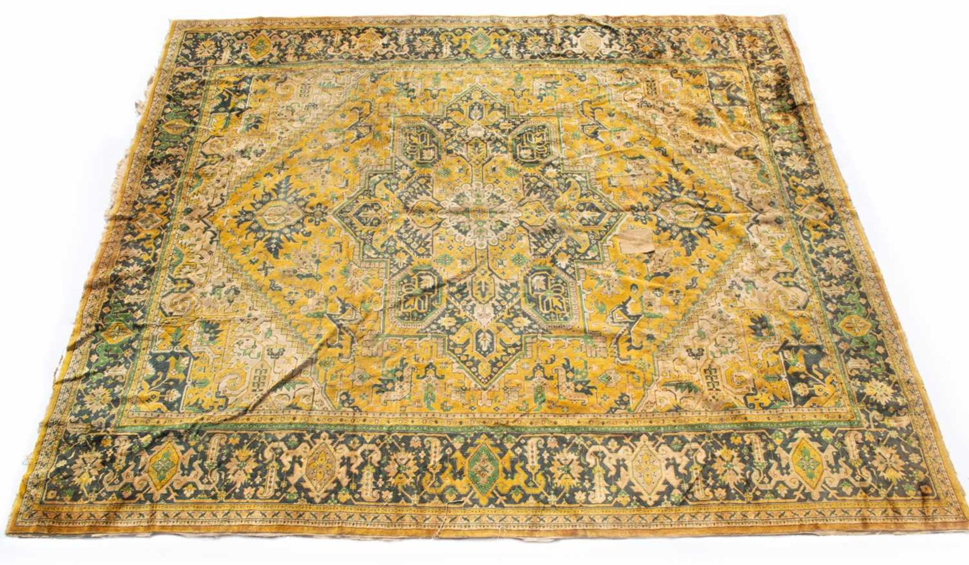 A modern 20th century blue and yellow ground small carpet, decorated with geometric designs within a