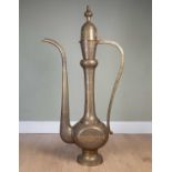 A large decorative Oriental brass display dallah coffee pot with floral chased and engraved