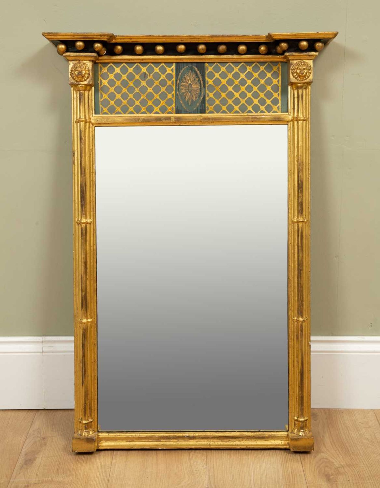 A Regency verre églomisé wall mirror with painted glass panel above the rectangular mirror plate