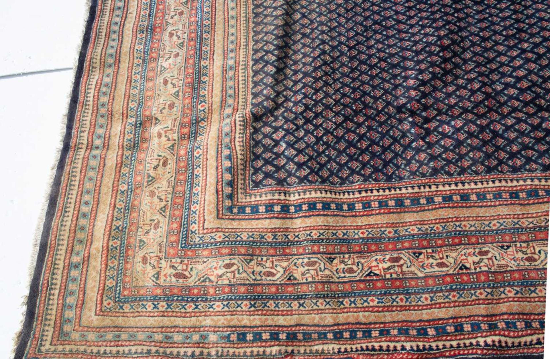 A modern Oriental blue ground carpet decorated with a mass of small, stylised flowers over the - Image 2 of 3