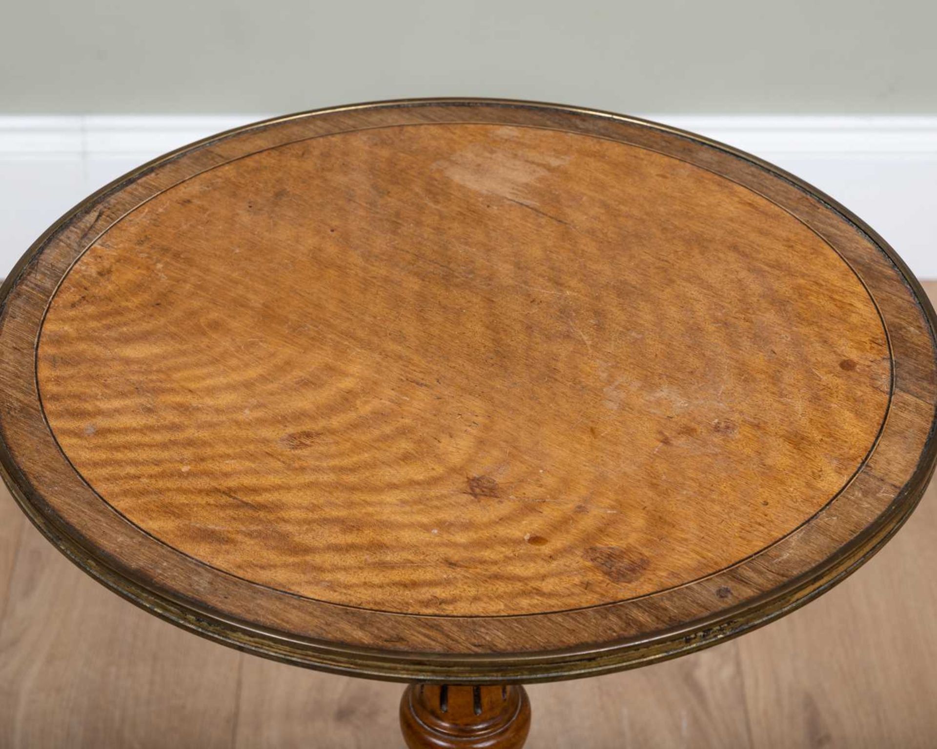 A satinwood circular tripod table with brass edging to the top and decorative inlay to the - Image 2 of 2