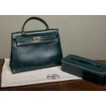 A Hermès 'Kelly' green leather handbag and matching jewellery case, the bag 33cm wide at the base
