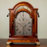 A George III mahogany bracket or table clock, the break arch silvered Roman dial with strike