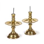 A pair of 17th century style Dutch brass Heemskerk candlesticks with later spikes, knopped stems,