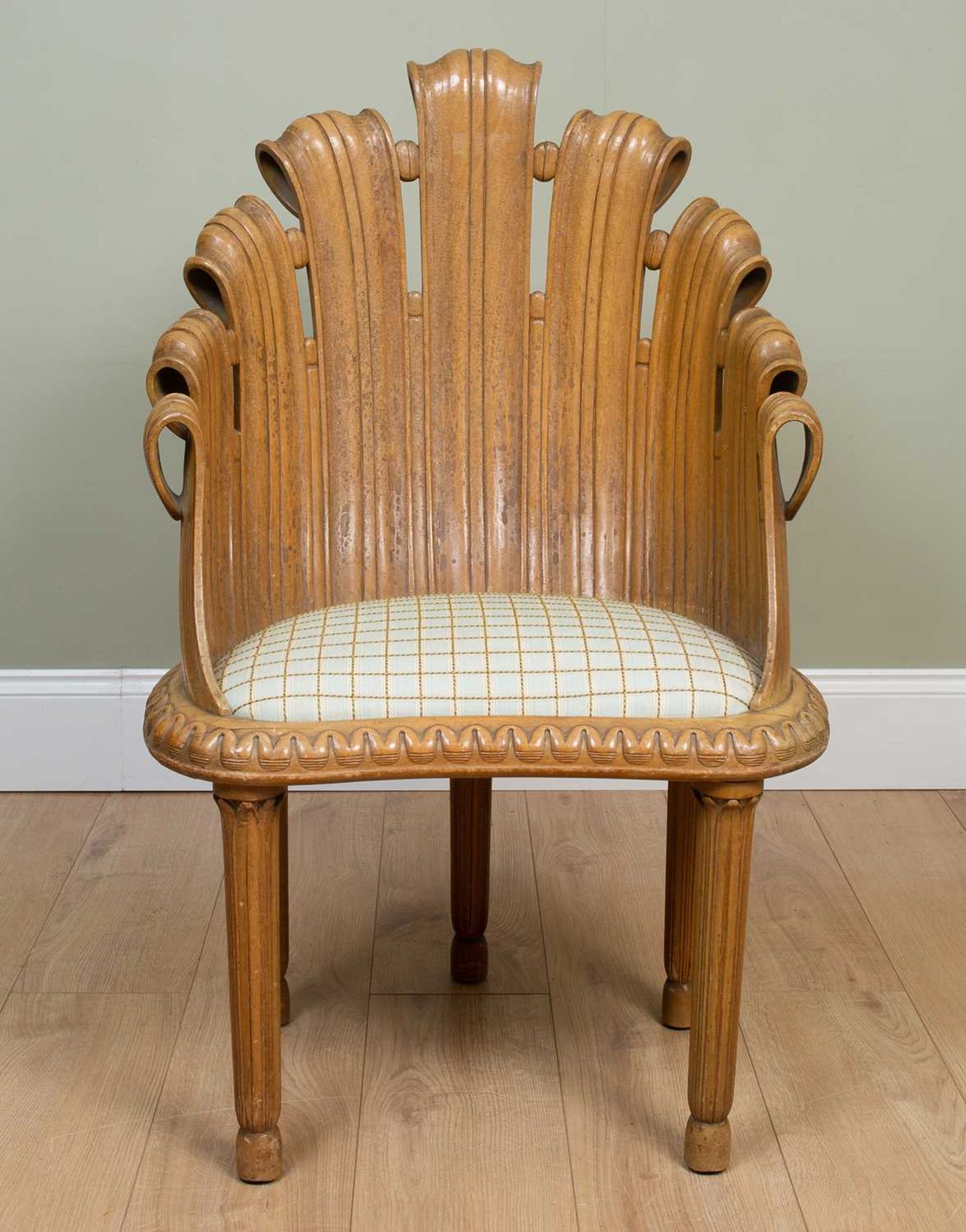 An Italian five-legged carved wood 'fan' chair with inset seat and reeded tapering legs, 60cm wide x