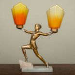 An Art Deco spelter and alabaster table lamp in the form of a dancing girl supporting two