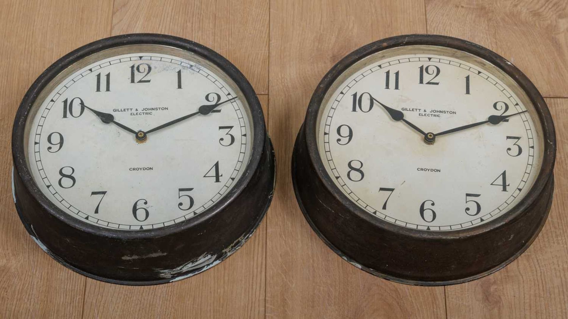 Two Gillett & Johnston electric wall clocks, the cases in bronzed tin with Arabic numerals to the - Image 2 of 3