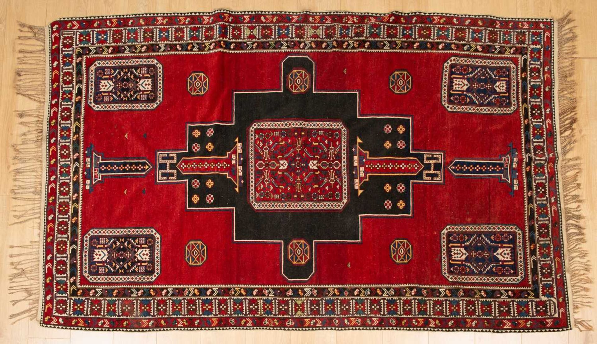 An antique red ground rug with central black ground motif and within a triple banded border, 228cm x - Bild 2 aus 6