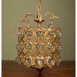 A gilt metal pendant or hanging light with spherical glass drops and moulded decoration, 30cm