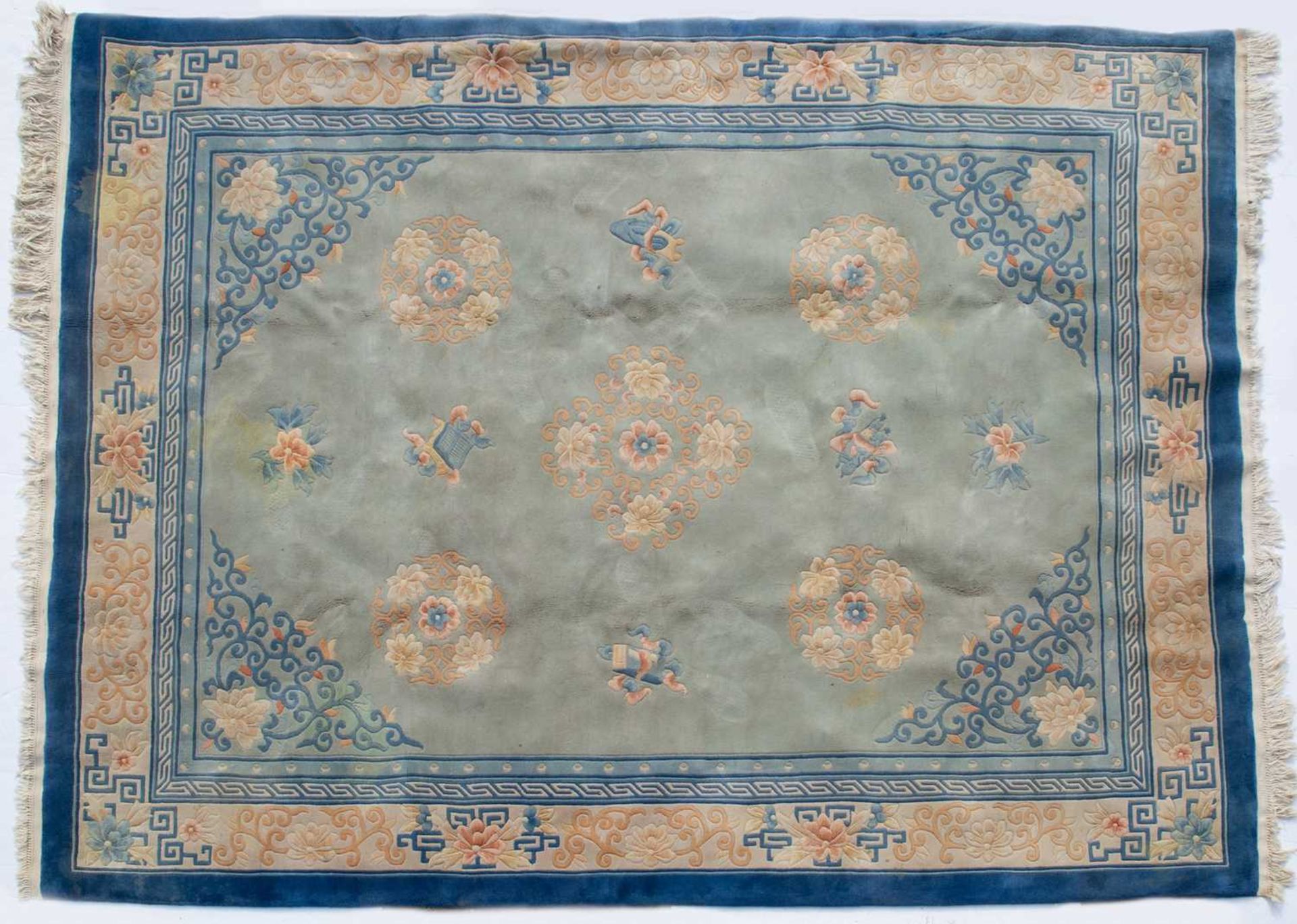 A Chinese light blue ground carpet with floral decoration and blue border, 314cm x 244cmStains,