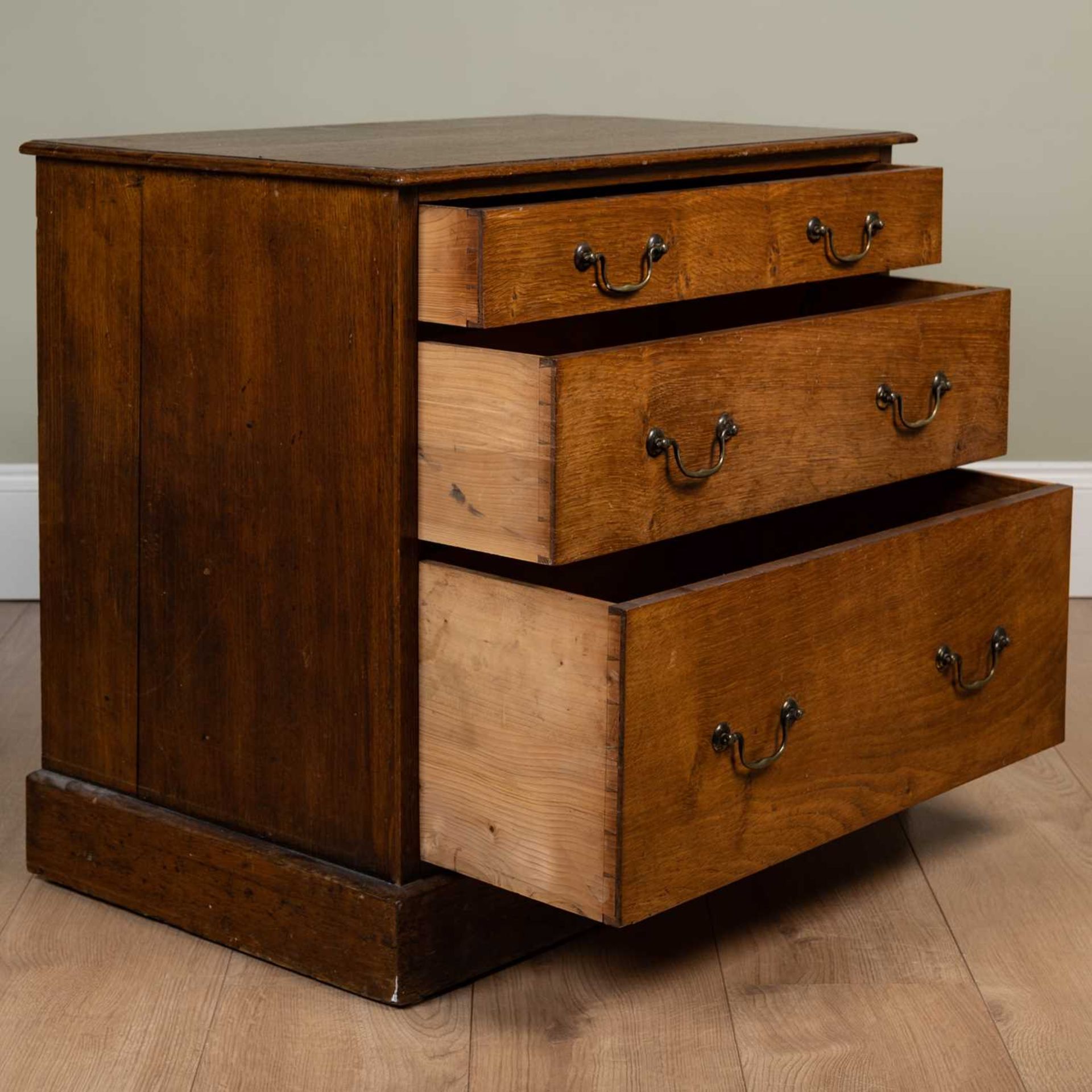 A 19th century oak three graduated drawer chest with swan neck brass handles, on a plinth base, 70cm - Image 2 of 3