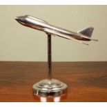 A decorative chrome plated desktop aeroplane model on a circular spreading base, 38cm wide x 38cm