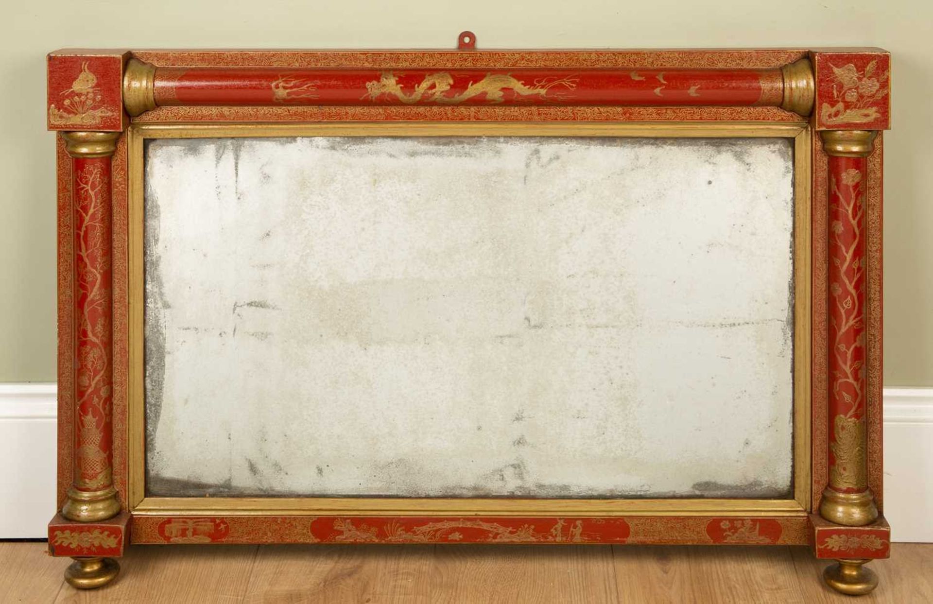 A Regency overmantle mirror the later red ground chinoiserie decorated frame with pilaster columns
