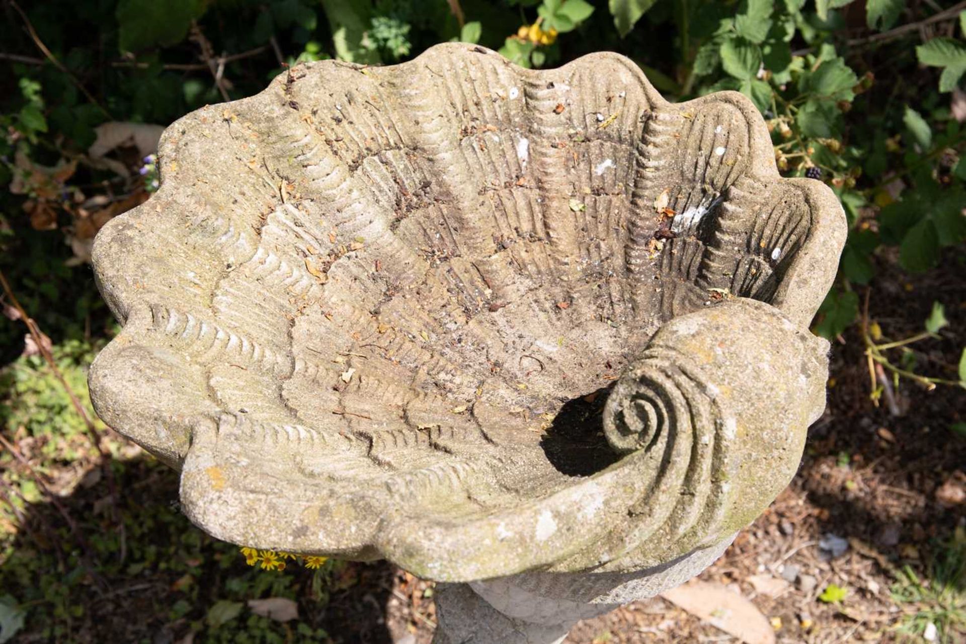 A cast reconstituted stone bird bath in the form of a shell supported by a dolphin, 52cm wide x 76cm - Image 2 of 5