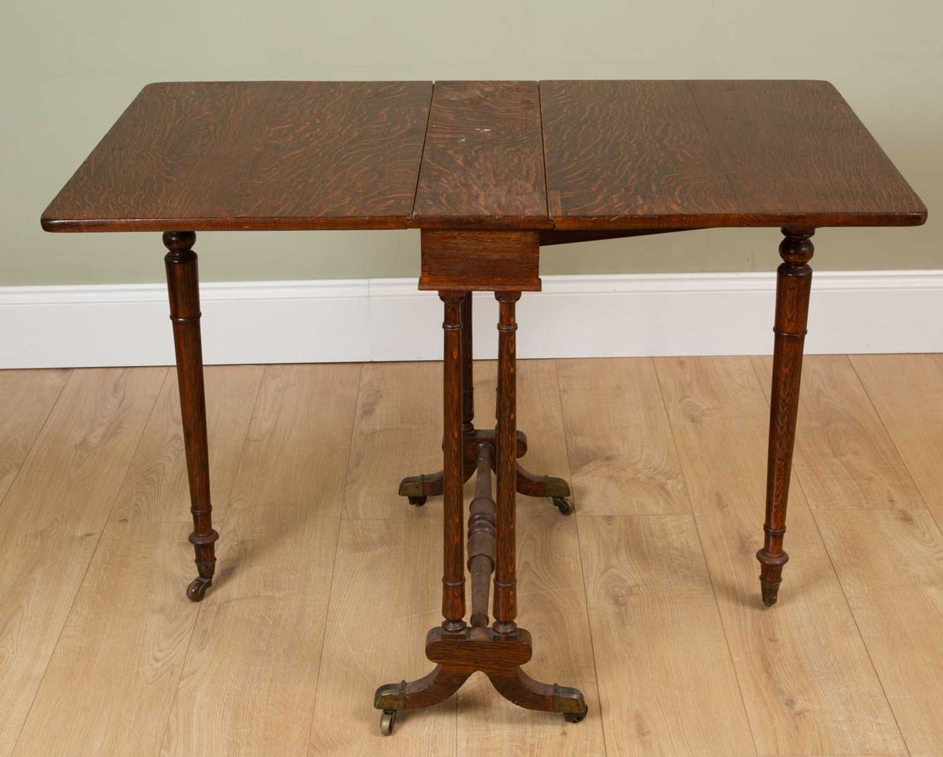 A Victorian oak Sutherland table with turned tapering legs and turned supports terminating in - Image 2 of 4