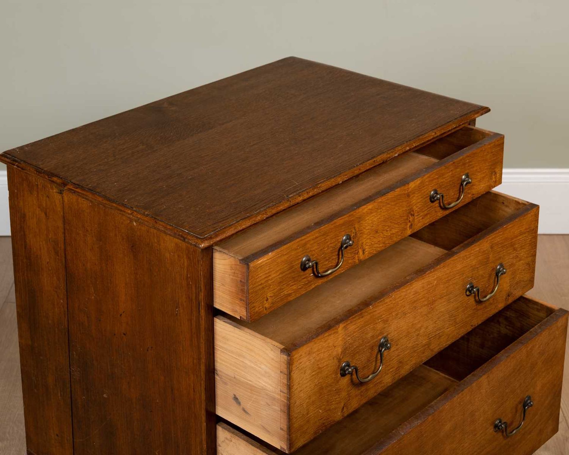 A 19th century oak three graduated drawer chest with swan neck brass handles, on a plinth base, 70cm - Image 3 of 3