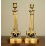 A pair of matched brass candlesticks, of triangular column form on triform bases, unmarked, 29.5cm